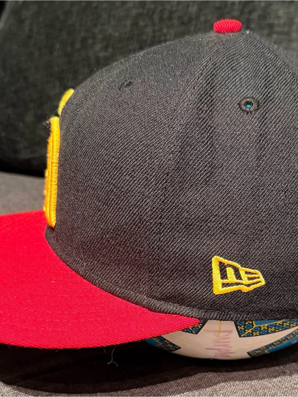 New Era Black Cap with Red Brim and Yellow Logo